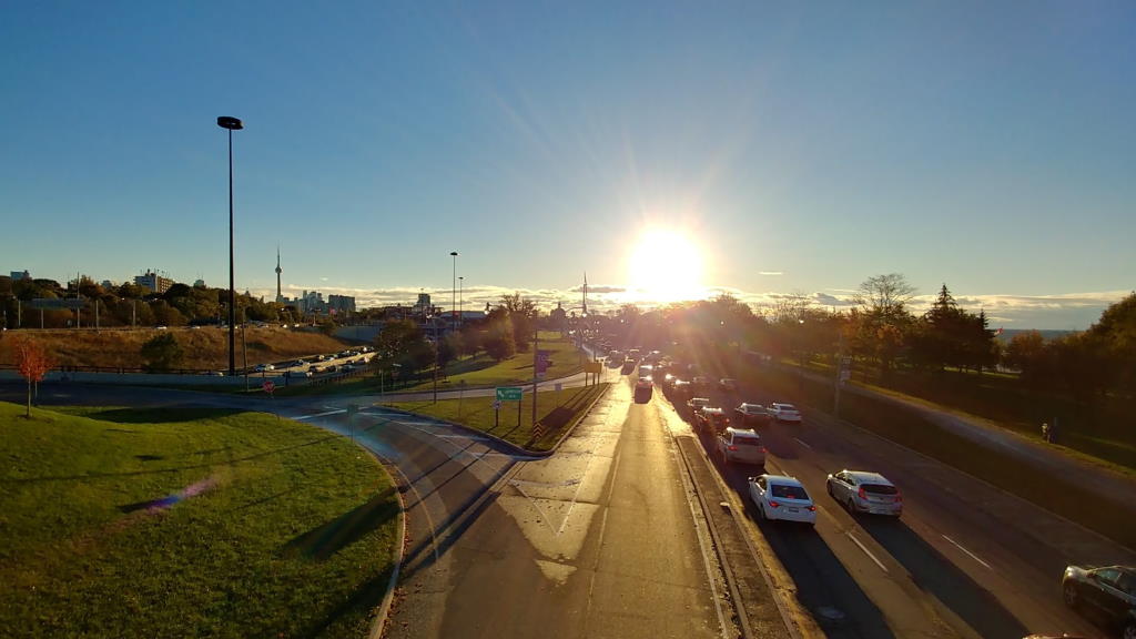 A photograph of a sunrise over a busy road