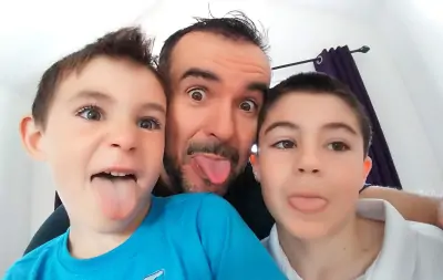 Photo of me and my two sons sticking our tongues out at the camera.